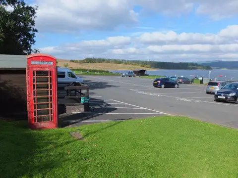 NY6687 : Car park with red telephone box, Leaplish