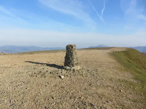 NY3415 : Trig point & summit ridge, Helvellyn