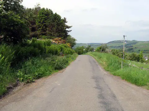 NT8327 : Hill road leading to Kirk Yetholm in Roxburghshire