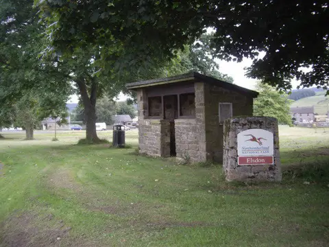 NY9393 : Village sign and shelter, Elsdon